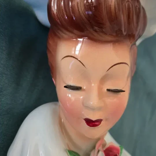 A photo of a vintage lady head vase, ready to scan